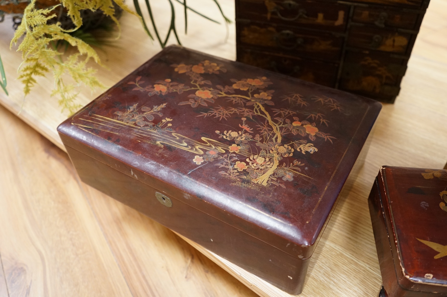 A group of 19th/20th century Japanese lacquer boxes and a similar tabletop cabinet, the latter 31cm wide